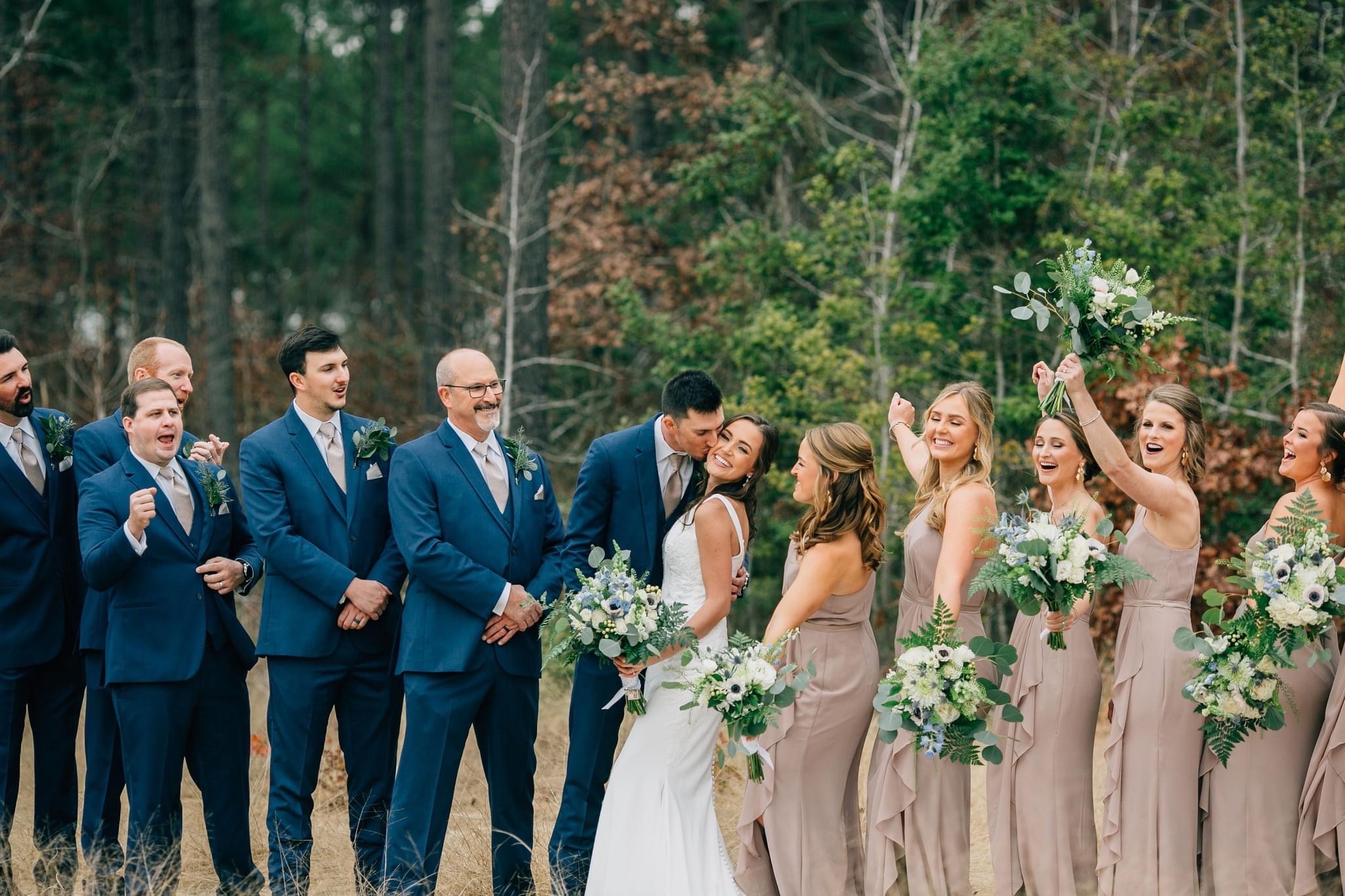 Wedding party celebrating together among the trees