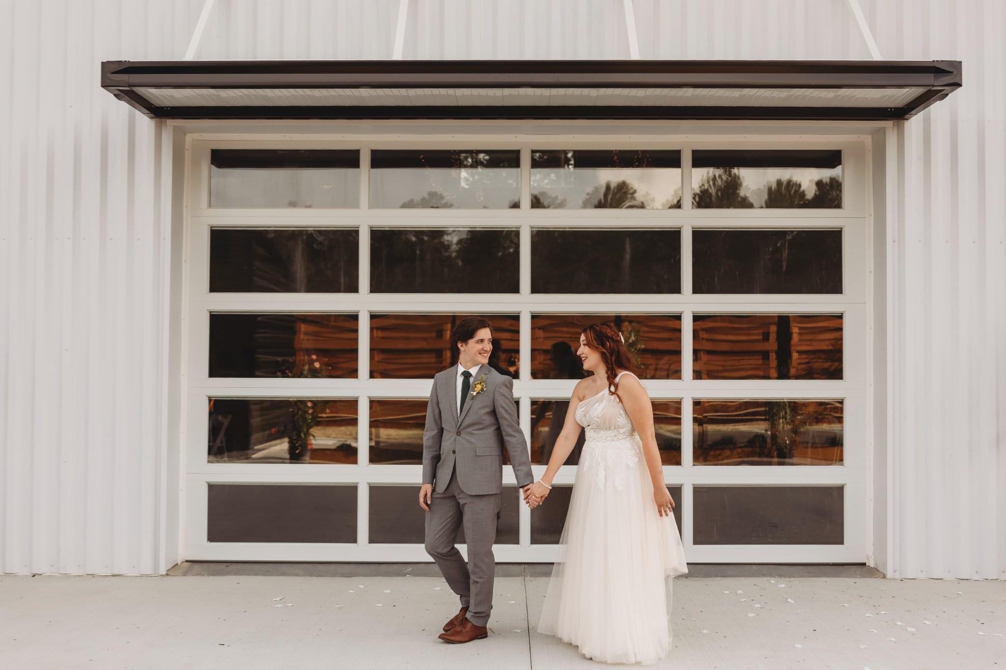 A wedding portrait outside the venue’s signature glass garage door
