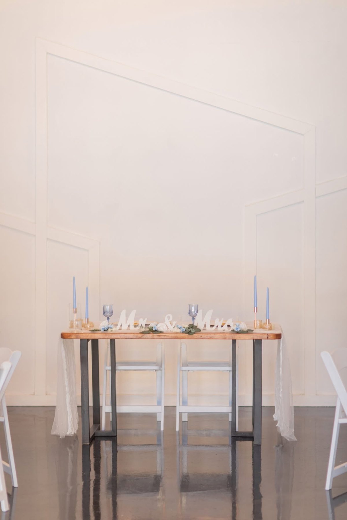 Sweetheart table with pale linens inside the venue