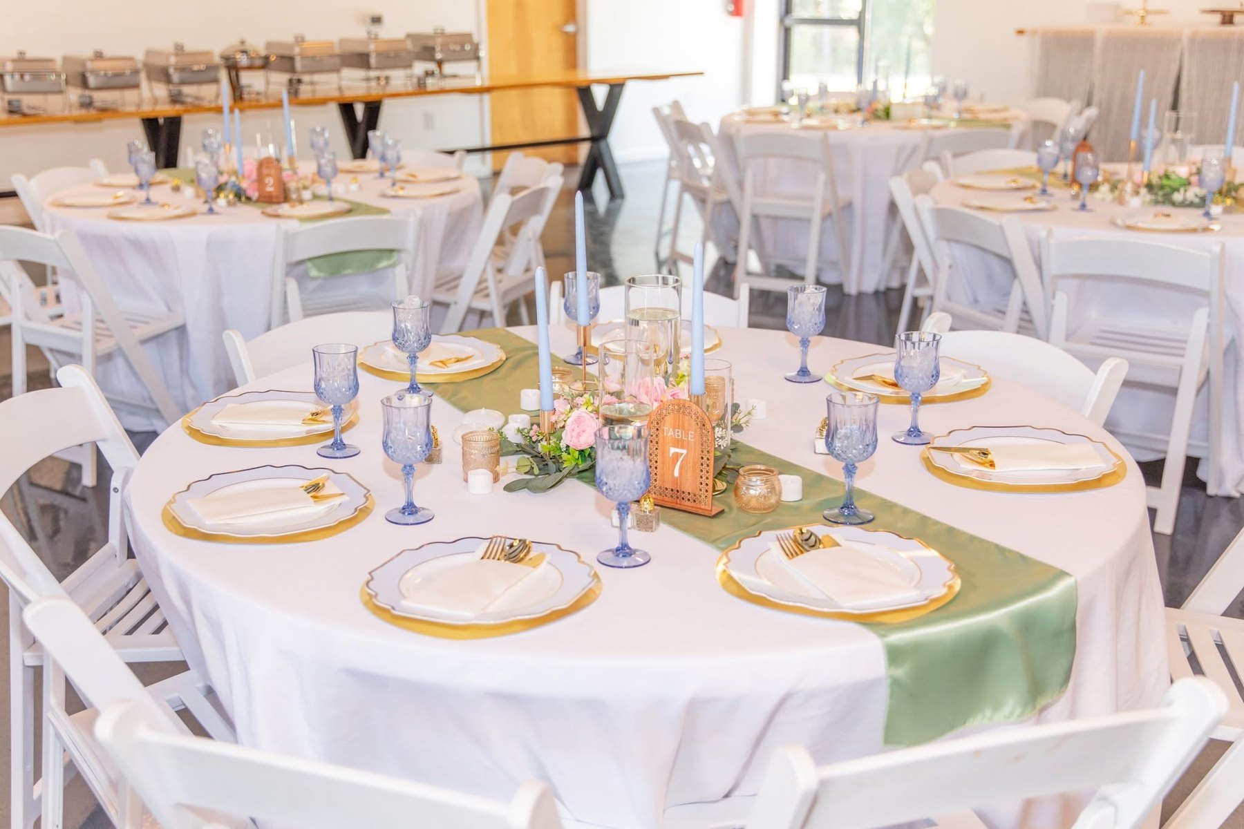 Pastel linens, flowers, and gold place settings at a real Factory 633 reception