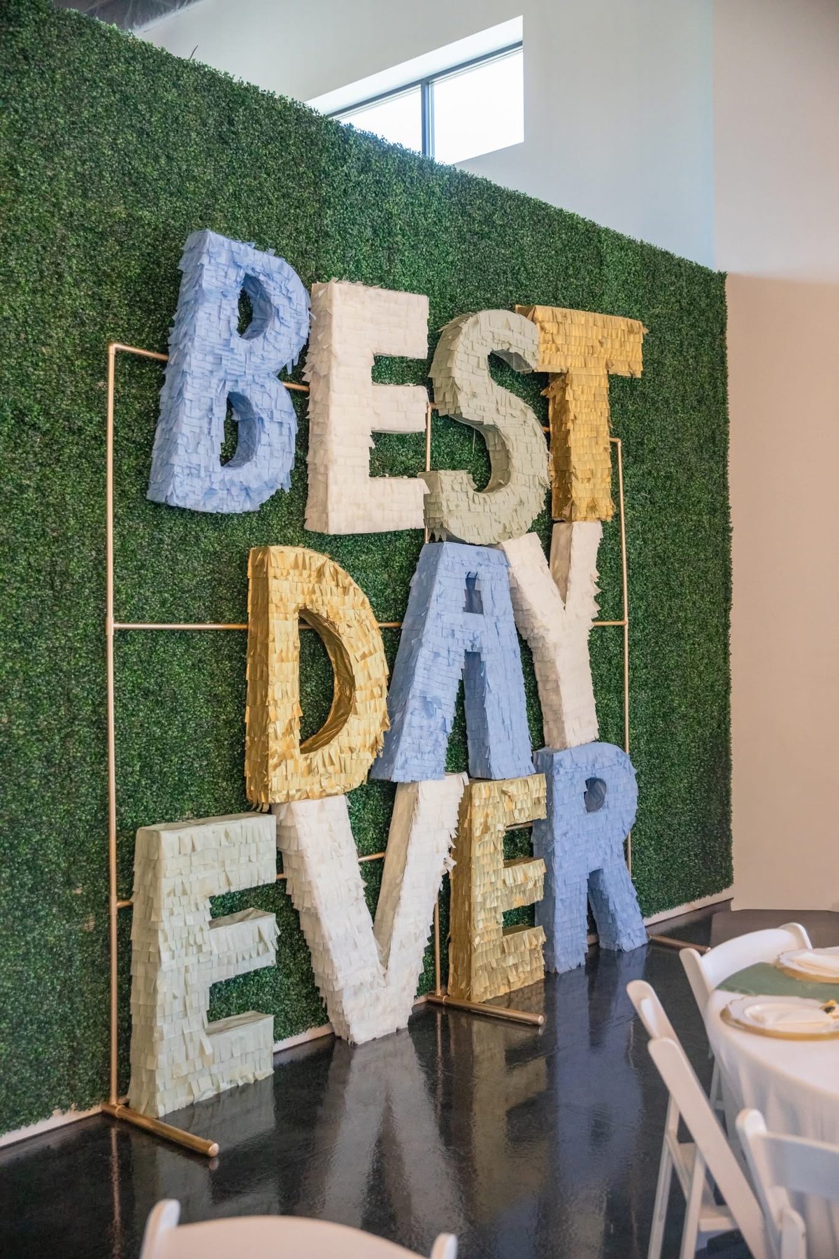 The Best Day Ever lettering on the greenery wall