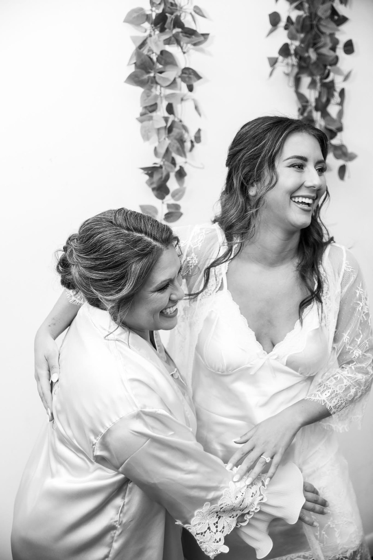 A quiet getting-ready moment between a bride and a loved one